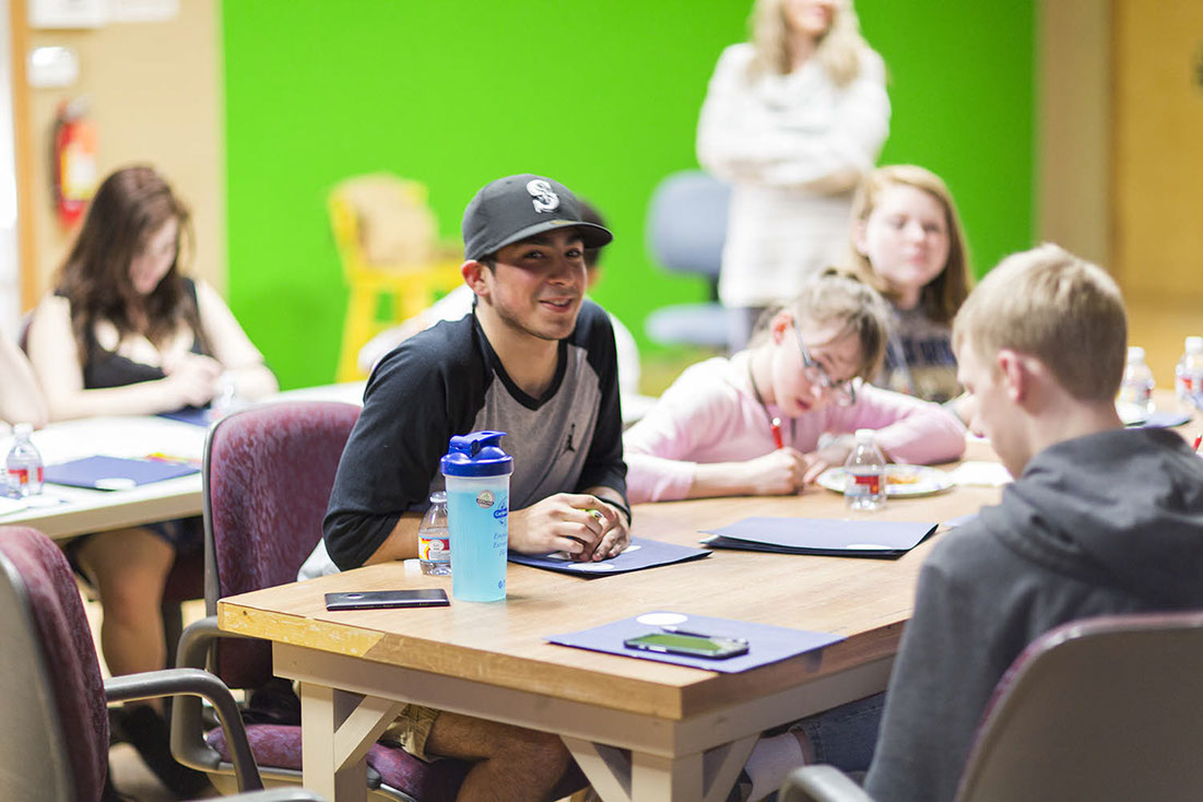 teen male at table smiling